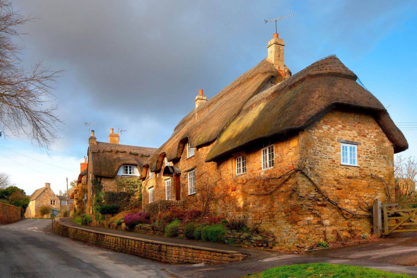 Thatched stone cottages in a Cotswold village